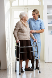 Cheerful eldery woman talking to care worker